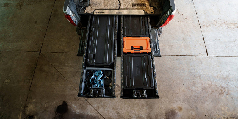 Blaze Orange DECKED Sixer 16 stowed in the open drawer of a DECKED Drawer System, seen from above