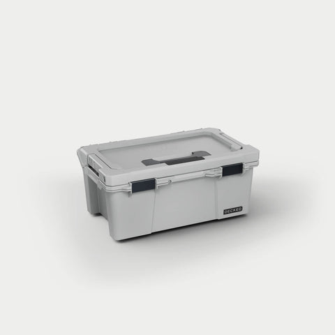Cool Gray DECKED Sixer 16 D-co case closed, three-quarter studio view showing the lid handle and black clutch latches