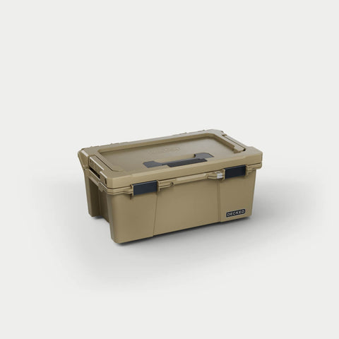 Desert Tan DECKED Sixer 16 D-co case closed, three-quarter studio view showing the recessed lid handle and black clutch latches