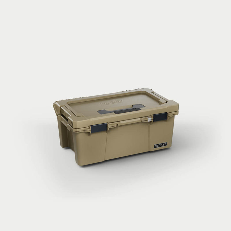 Desert Tan DECKED Sixer 16 D-co case closed, three-quarter studio view showing the recessed lid handle and black clutch latches