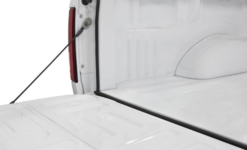 ACCESS TrailSeal rubber gasket installed down the side and along the bottom of a white pickup tailgate