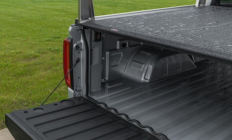 ACCESS TrailSeal gasket fitted along the tailgate gap of a pickup with a wet tonneau cover after rain