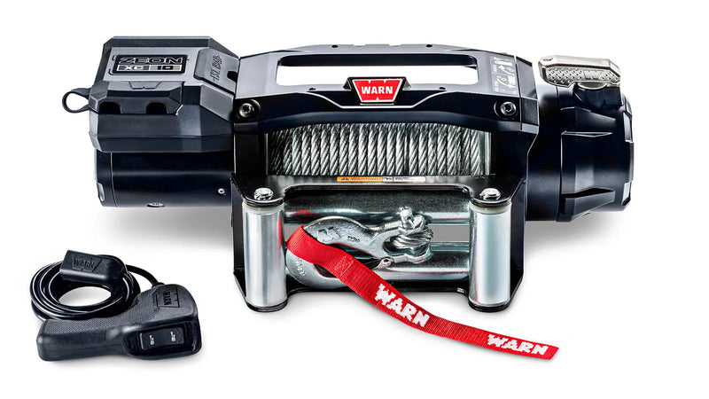 Warn ZEON XC 10 low-profile winch, front studio view with steel wire rope spooled, steel roller fairlead fitted and corded remote alongside