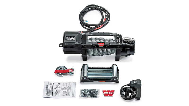 Warn ZEON XC 10 kit laid out: winch with steel rope, steel roller fairlead, hook, corded remote, mounting hardware and manuals
