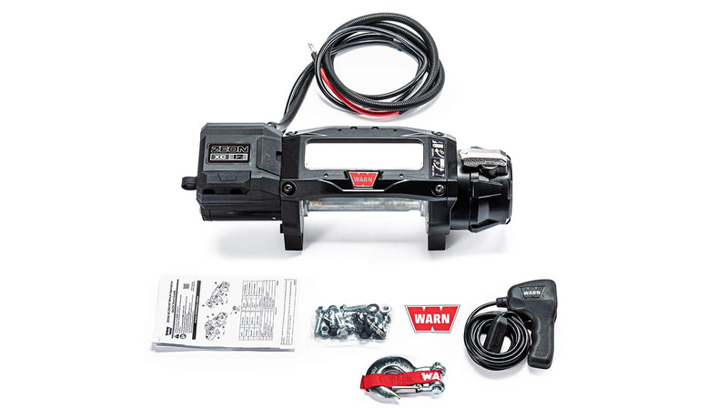 Warn ZEON XC 12 bare drum winch with an empty drum and no fairlead, shown with the corded remote, mounting hardware and manuals