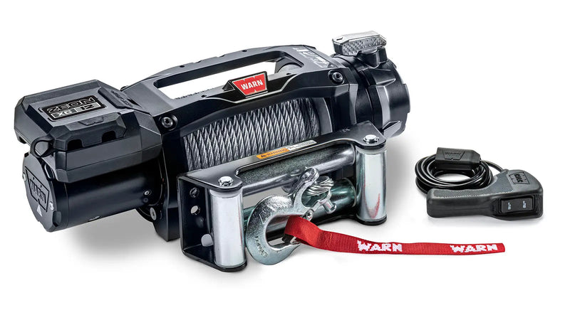 Warn ZEON XC 12 winch from an angle showing the low-profile control pack, steel wire rope on the drum and the roller fairlead