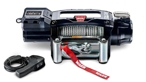 Warn ZEON XC 12 low-profile winch, front studio view with steel wire rope spooled, steel roller fairlead fitted and corded remote alongside