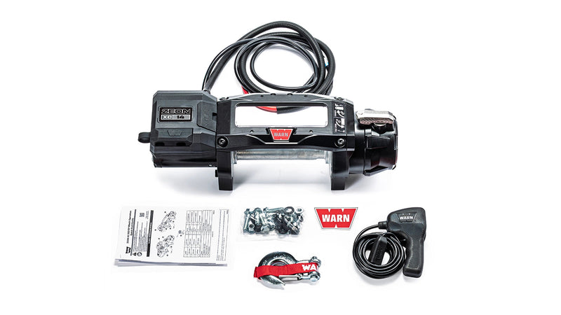 Warn ZEON XC 14 bare drum winch with an empty drum and no fairlead, shown with the corded remote, mounting hardware and manuals