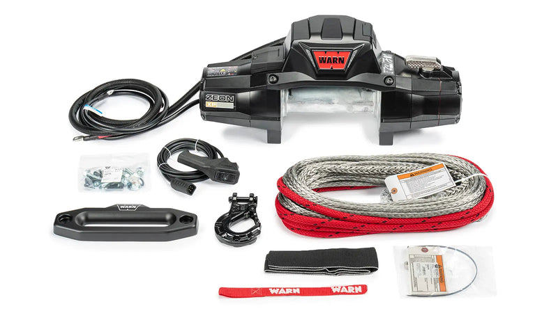 Warn ZEON XP 10-S kit laid out: winch, coiled Spydura synthetic rope, hawse fairlead, Epic hook, hook strap, remote lead and mounting hardware