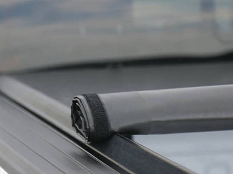 Close-up of the rolled cover end resting on the side rail