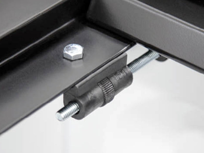 Close-up of the Access LiteRider roll-up tonneau cover: close-up of a black side-rail clamp with bolt threaded under an aluminum rail