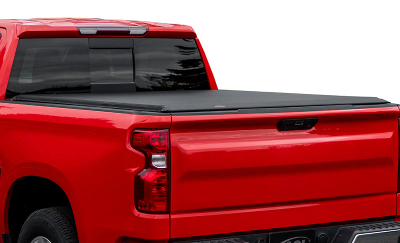 Full view of the Access LiteRider roll-up tonneau cover: red pickup on a white background with a black vinyl roll-up cover closed over the bed