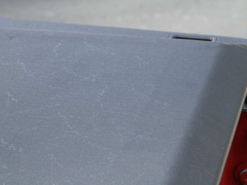 Close-up of the Access Lorado roll-up tonneau cover: close-up of the textured black vinyl surface of a closed roll-up cover