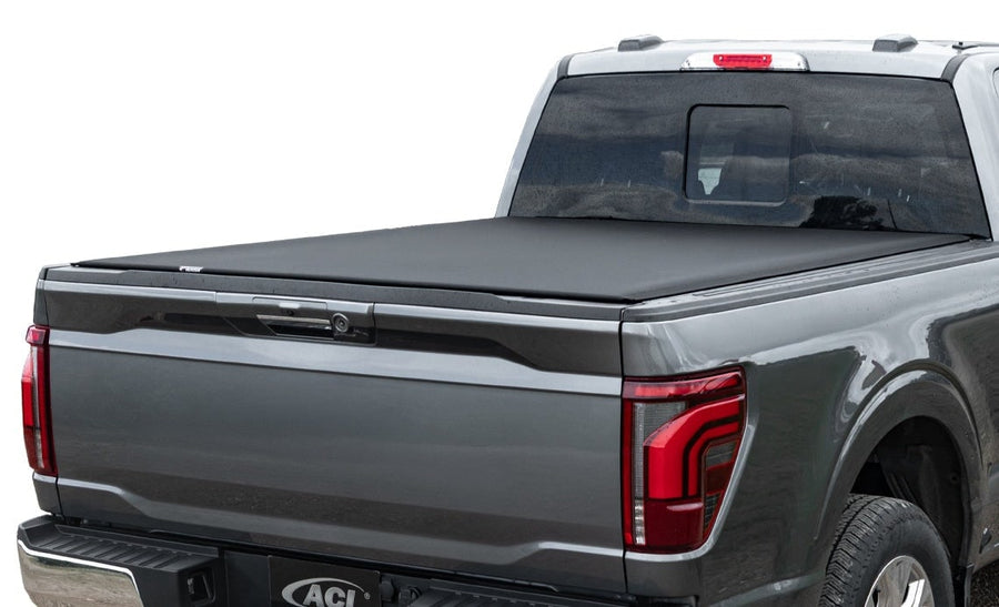 Access Vanish roll-up tonneau cover: Dark gray pickup on white background, black low-profile roll-up cover closed flat over the bed