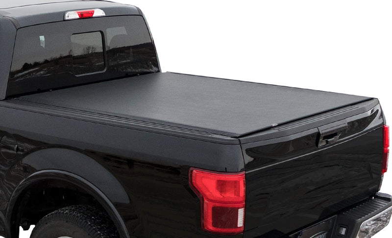 Access TonnoSport roll-up tonneau cover on a pickup bed: black pickup on white background, cropped to the bed with a low-profile roll-up cover closed