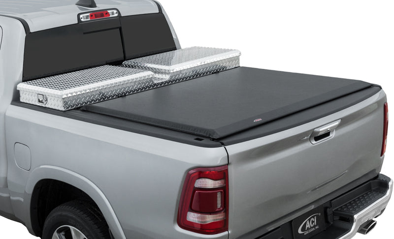 Access Toolbox Edition roll-up tonneau cover on a pickup bed: rear three-quarter view of a silver pickup, black roll-up cover closed behind an aluminum diamond-plate bed toolbox (truck-bed toolbox shown, not included)