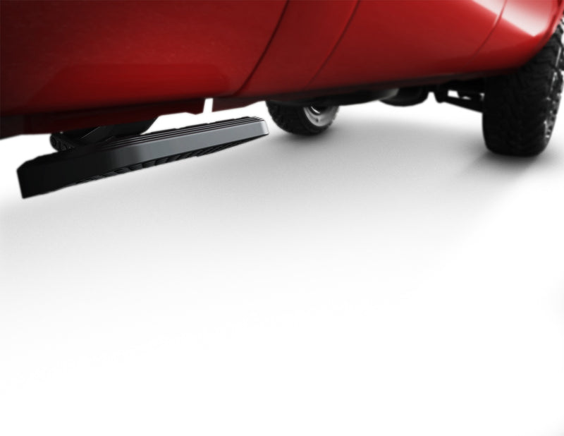 Side bed step folded under the bed of a red pickup, low studio view along the body