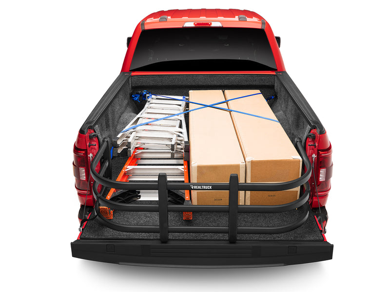 Overhead rear view of a red pickup bed with the BedXTender HD Max extended, corralling boxes and a ladder