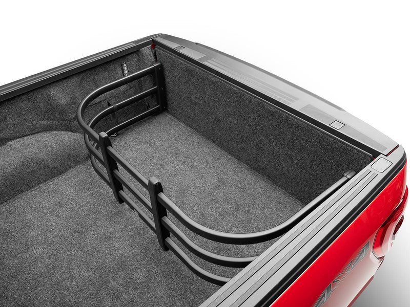 BedXTender HD Max turned inward to form a cargo corral against a closed tailgate in a carpeted bed