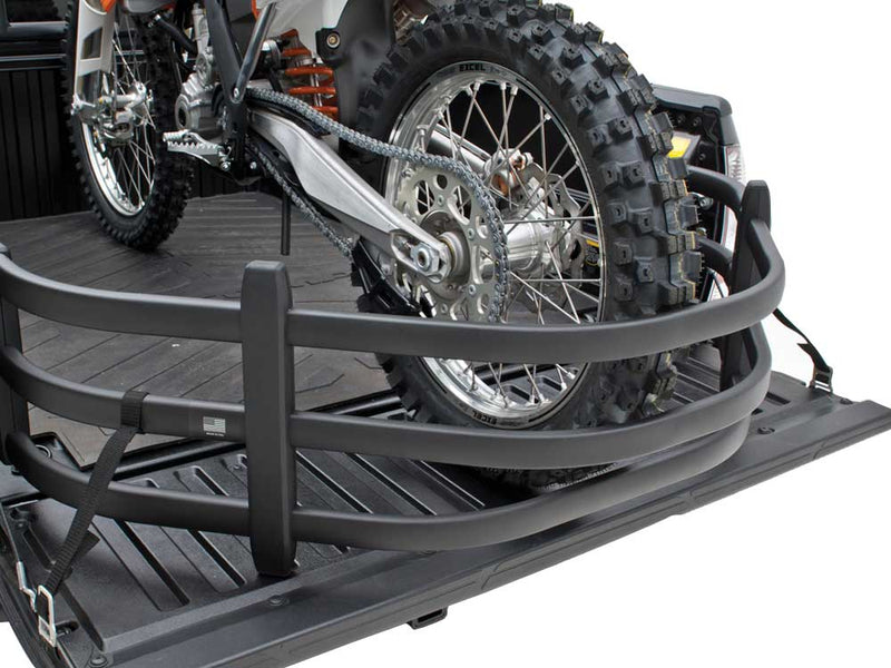Rear wheel of a dirt bike held inside the extended BedXTender HD Moto on the lowered tailgate