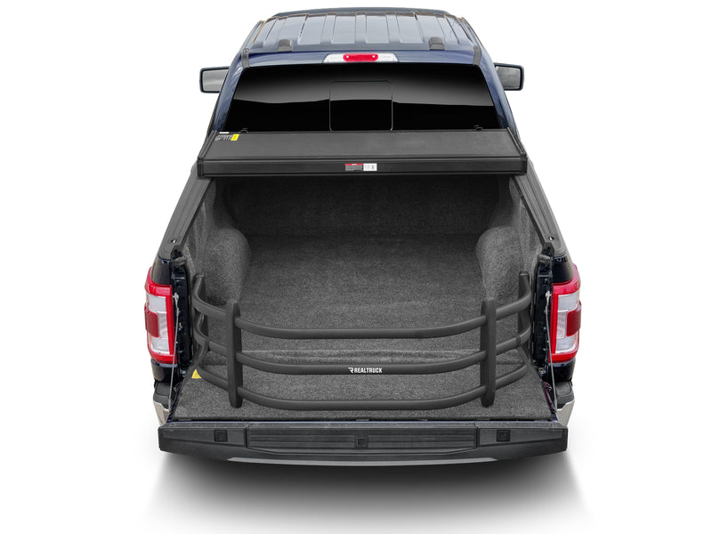 Rear view of an empty pickup bed with the BedXTender HD Sport extended over the lowered tailgate