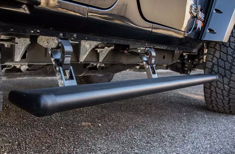 PowerStep deployed under the doors of a black off-road SUV, low close view