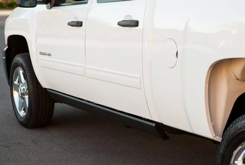 White crew-cab pickup doors with the running board stowed beneath