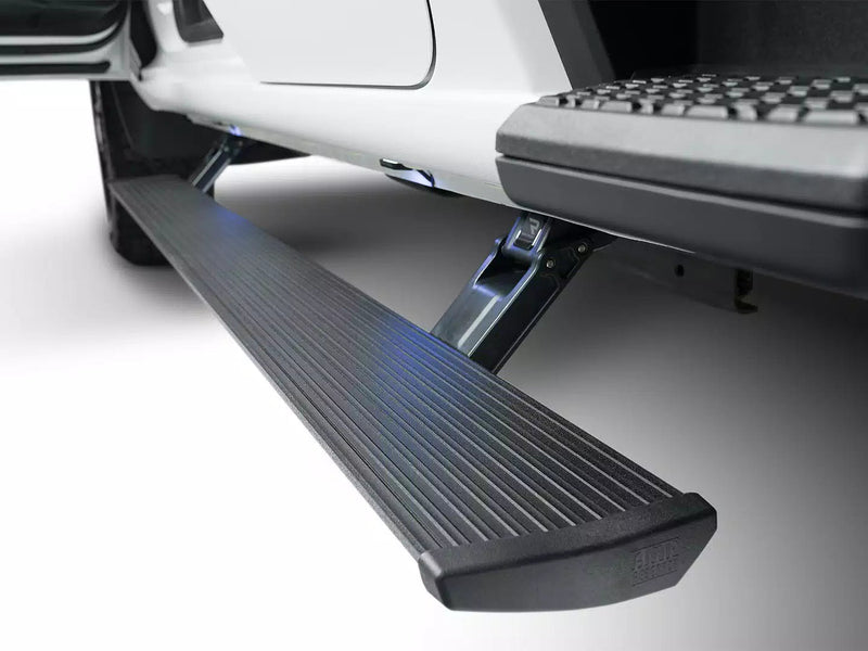 Close-up of the lit PowerStep step deployed below a white pickup