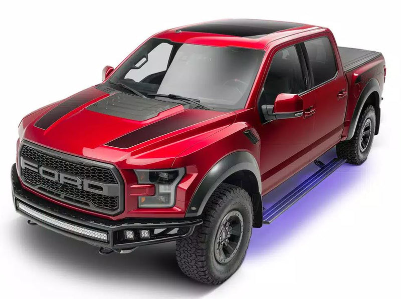 Red off-road pickup in the studio with the lit running board deployed, front three-quarter view