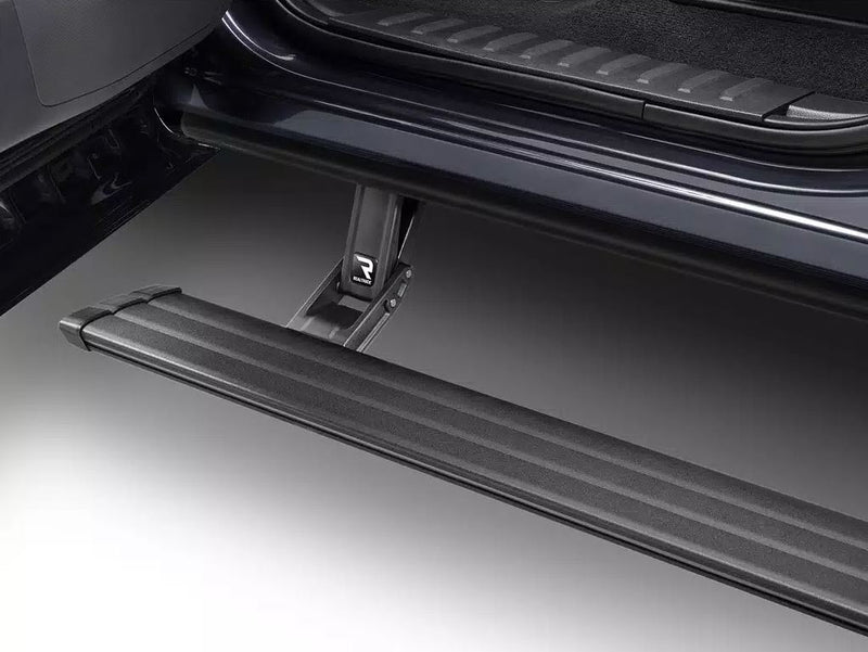 Running board deployed under the doors of a dark vehicle, studio