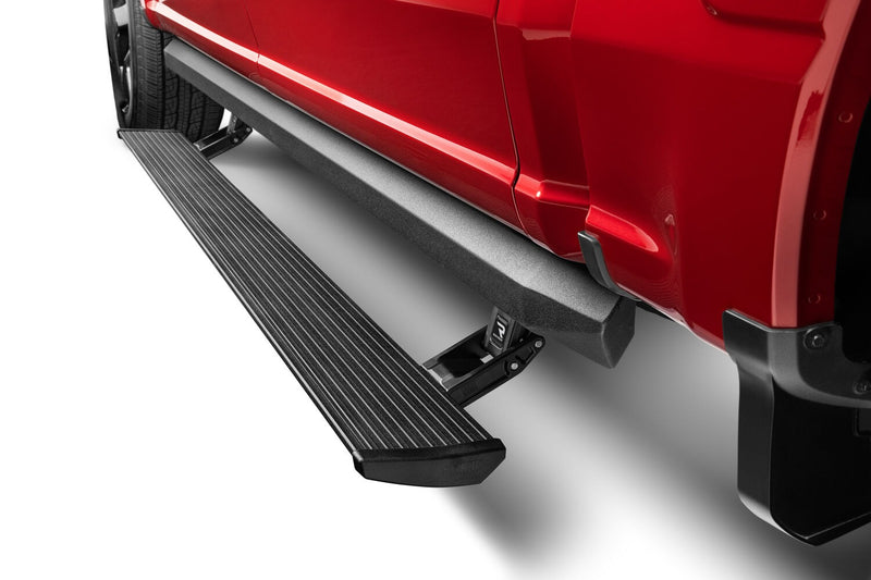 PowerStep XL deployed below the doors of a red pickup, studio