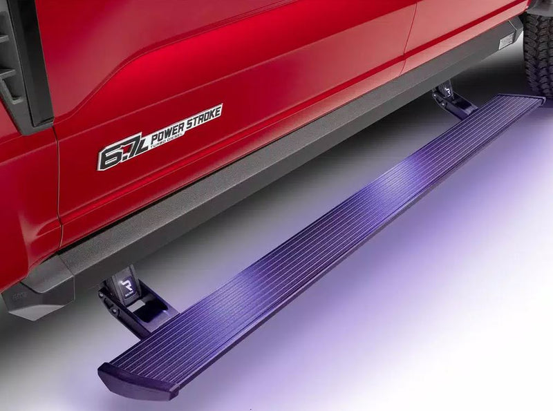 Lit running board deployed under a red pickup door beside a 6.7L Power Stroke badge