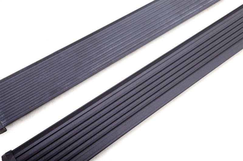Pair of black PowerStep Xtreme running boards on a white background