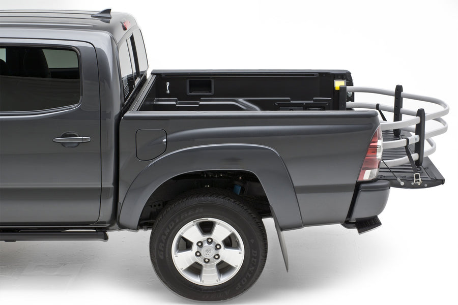 Gray crew-cab pickup in the studio with a silver BedXTender HD Moto extended over the lowered tailgate