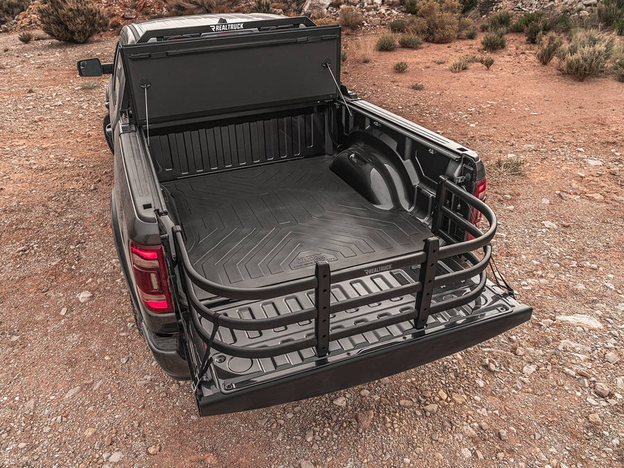 Dark pickup parked on red desert dirt with the tailgate down and the BedXTender HD Max extended, seen from above