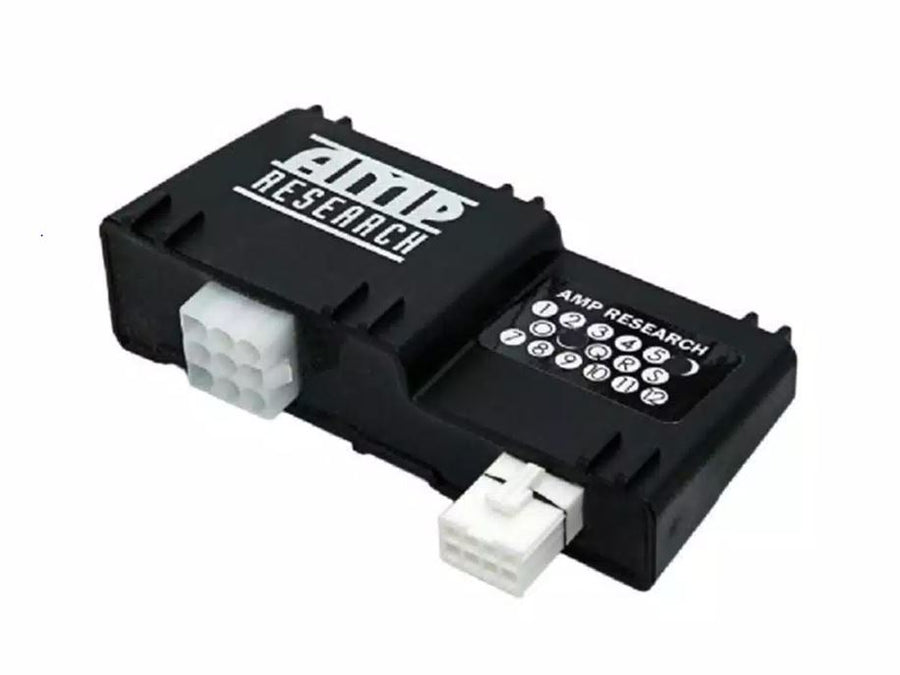 Black AMP Research PowerStep controller with two white connectors on white