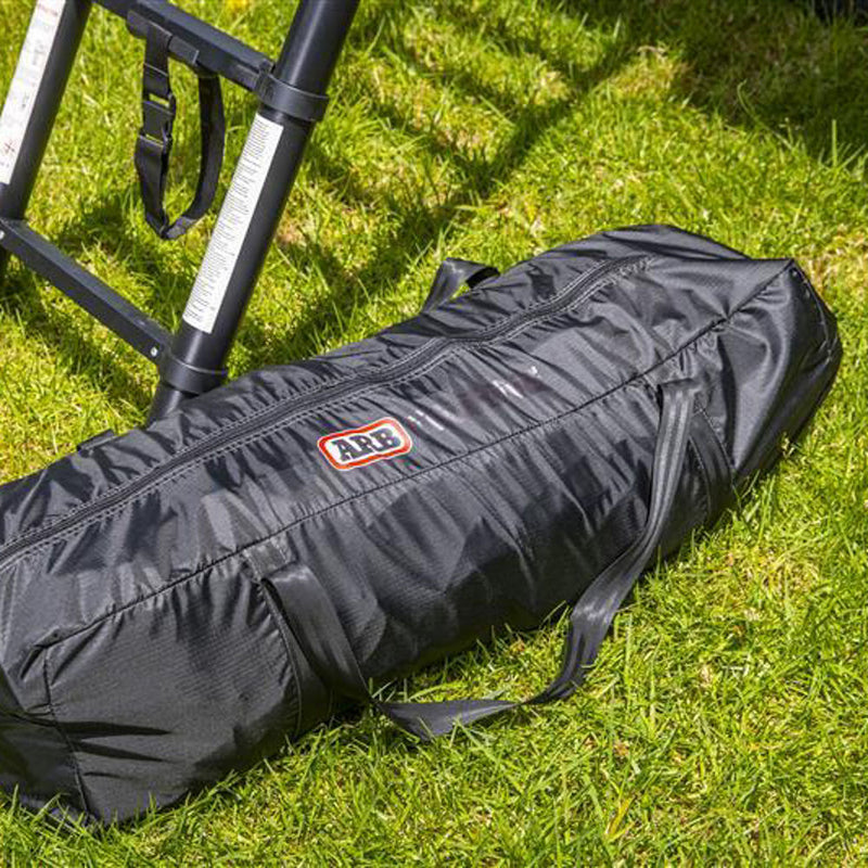 ARB Esperance V2 Annex 804200V2 packed into its black ARB-branded zip storage bag with carry handles, on grass beside the tent ladder