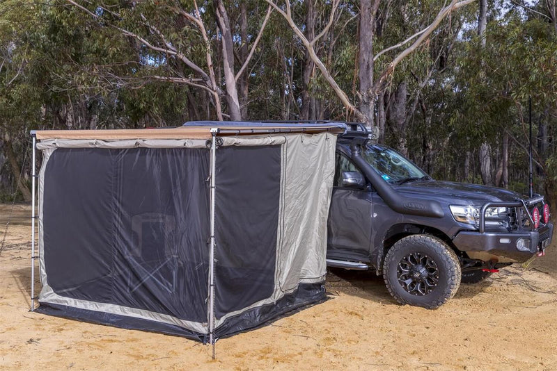 ARB awning room with floor pitched against a grey Land Cruiser with the mesh insect panels zipped in under a tan awning