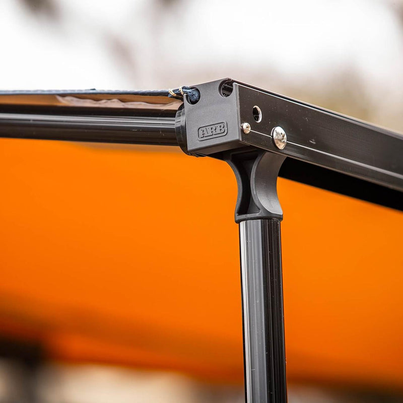 Macro of the ARB Hard Case Awning 814412A cast ARB-branded leg knuckle joining the front rail to the telescopic support leg