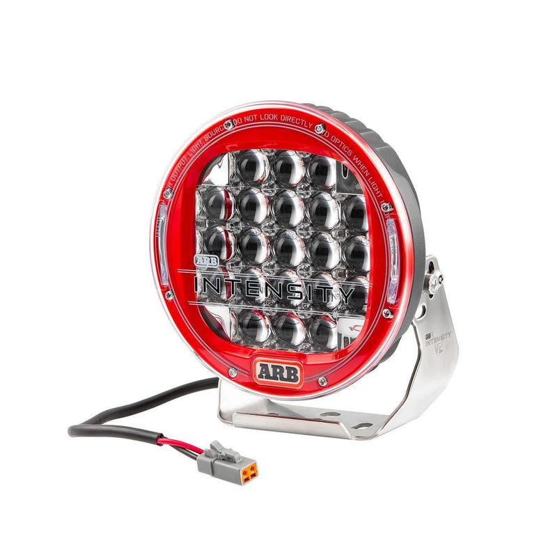 ARB Intensity V2 AR21FV2 driving light front view, red bezel ring around a clear lens with 21 square OSRAM LEDs behind faceted reflectors, stainless steel bracket and Deutsch pigtail
