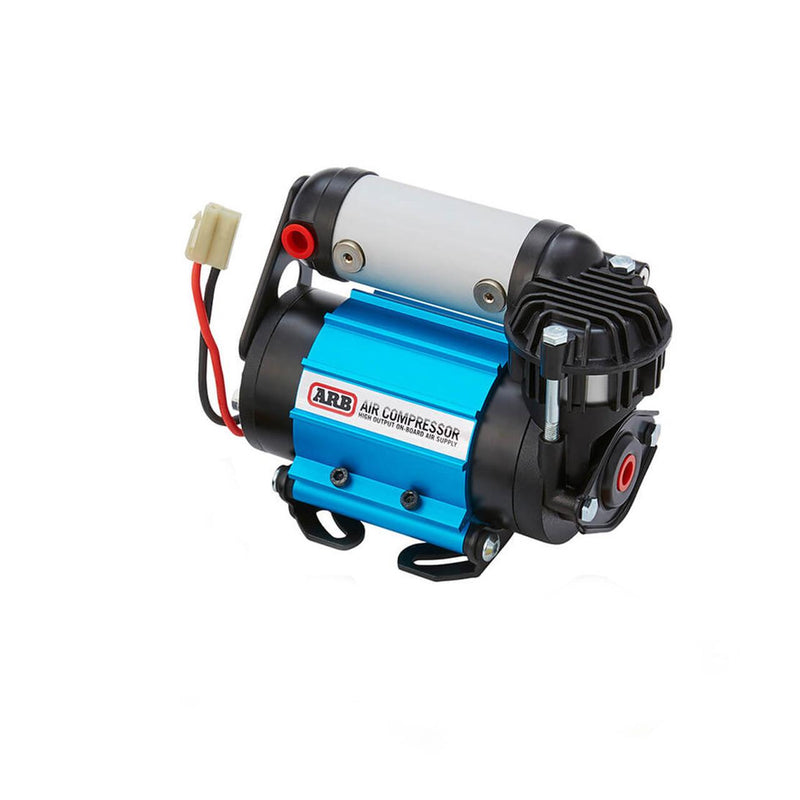 ARB CKMA12 on-board 12V air compressor studio view, blue anodized single-motor body with black finned head, filter cage and wiring pigtail