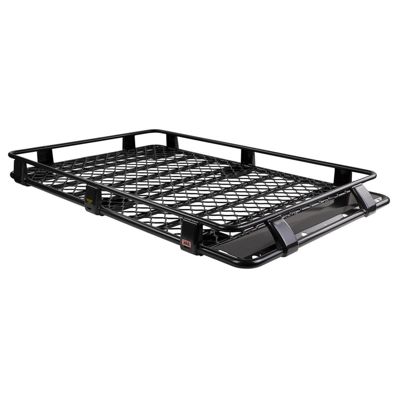 ARB Classic aluminum roof rack cage with a mesh floor on white, showing raised perimeter rails over a diamond pattern mesh deck, mounting legs and a wind deflection panel