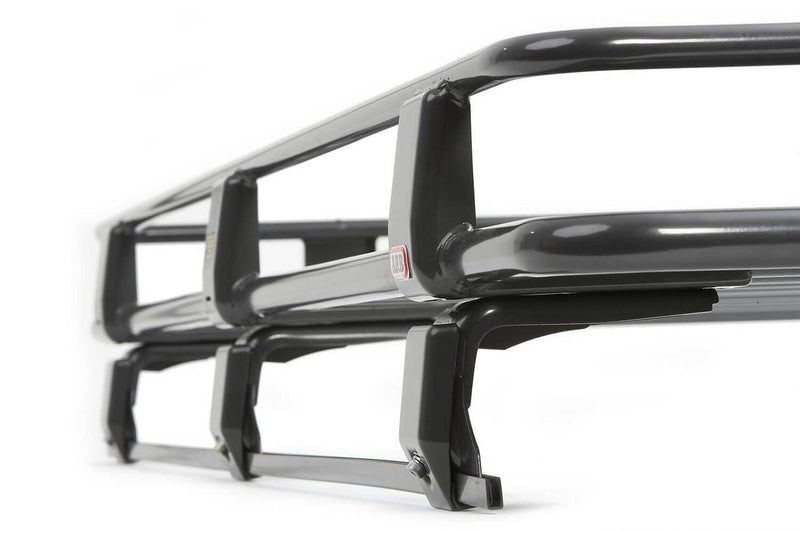 Low close-up along the side of an ARB Classic roof rack cage showing the raised rail uprights and mounting legs