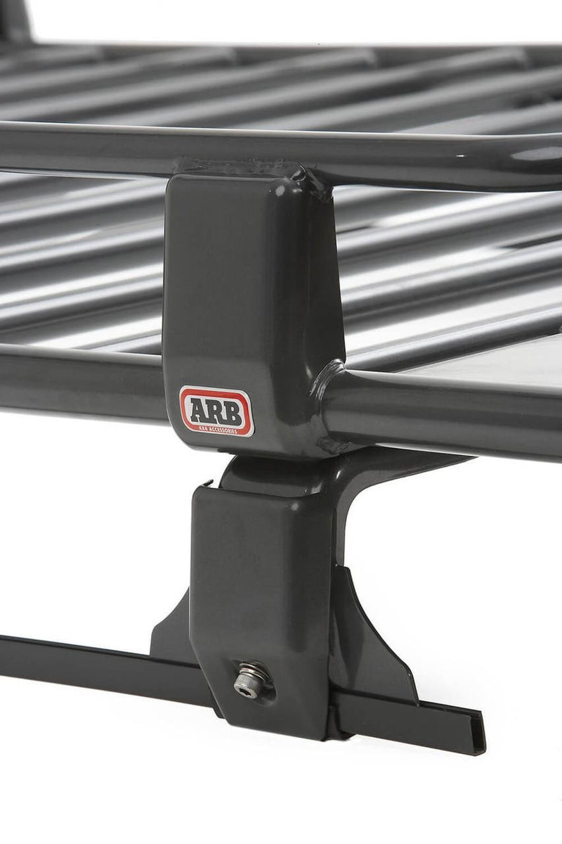Close-up of an ARB Classic roof rack mounting leg with the ARB logo, clamped to a square load bar