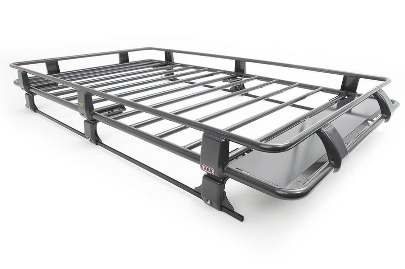 ARB Classic steel roof rack cage on white, a large dark grey round tube rack with raised perimeter rails, spaced cross bars, mounting legs and a wind deflection panel at one end