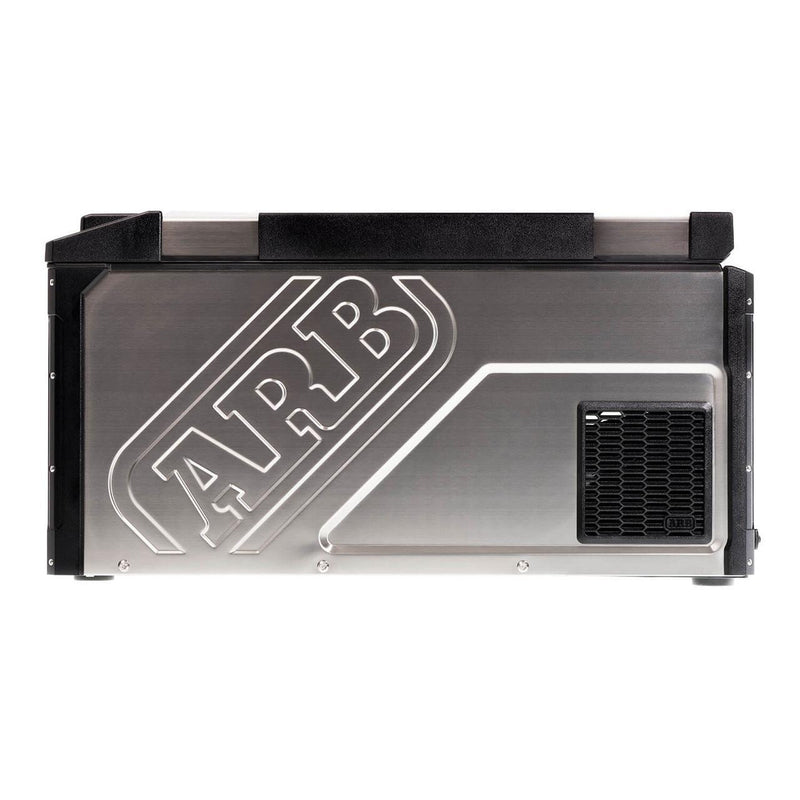 Side elevation of the ARB Elements 63 qt fridge freezer showing the embossed ARB logo in the stainless panel and the black vent grille over the compressor bay