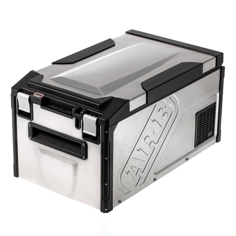 ARB Elements 63 qt weatherproof fridge freezer, three quarter studio view showing the brushed 304 stainless body with embossed ARB logo, black corner armor, latches and weatherproof control panel