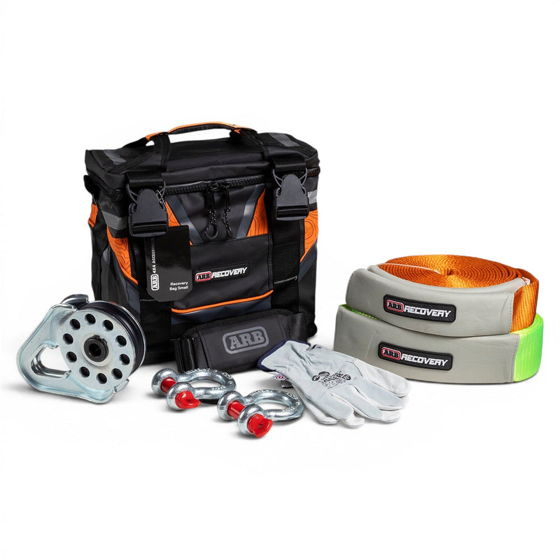 ARB Essentials Recovery Kit laid out with recovery bag, snatch strap, tree trunk protector, snatch block, shackles and gloves
