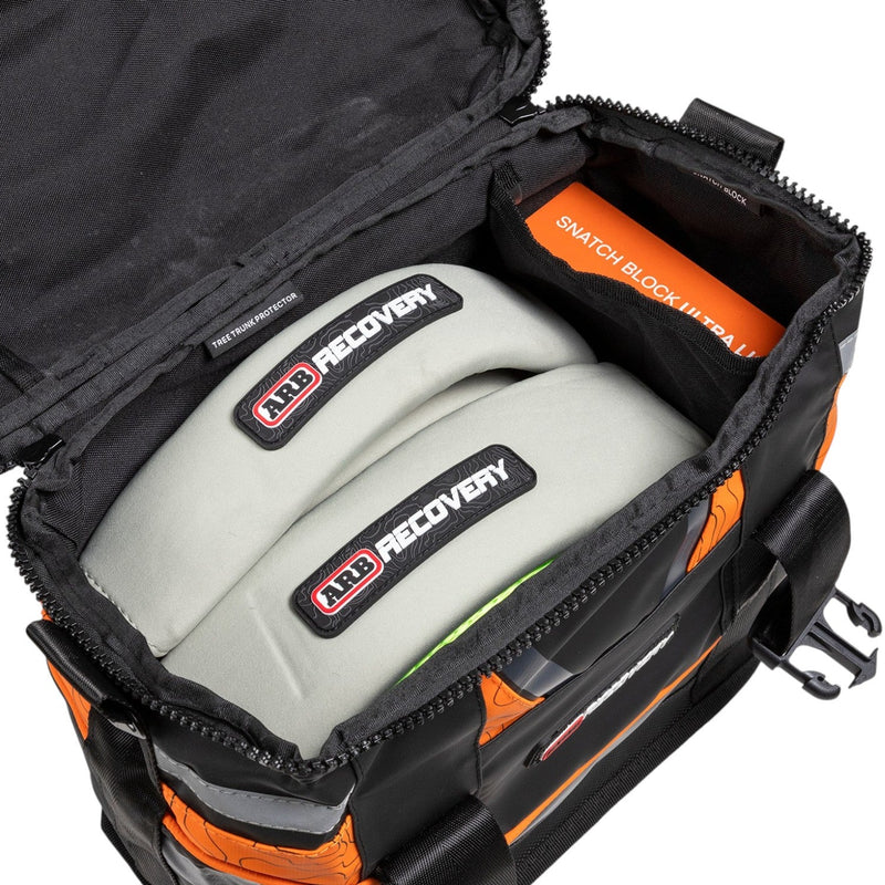 ARB Essentials Recovery Kit laid out with recovery bag, snatch strap, tree trunk protector, snatch block, shackles and gloves, underside view