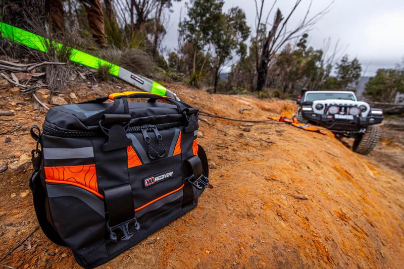 ARB Essentials Recovery Kit laid out with recovery bag, snatch strap, tree trunk protector, snatch block, shackles and gloves, additional view